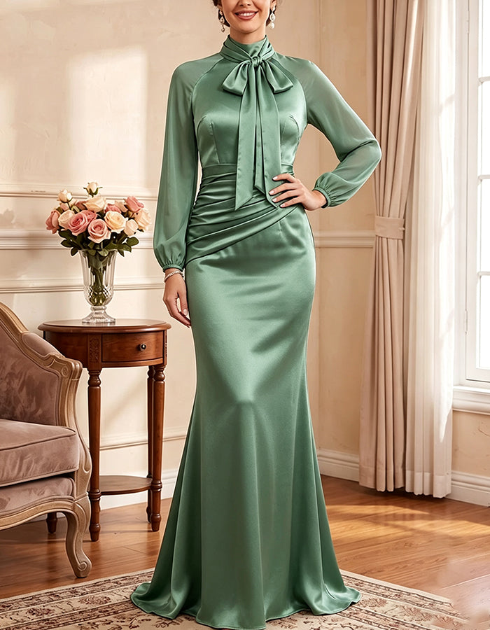 Vestido largo de satén verde salvia, con lazo en el cuello y mangas largas