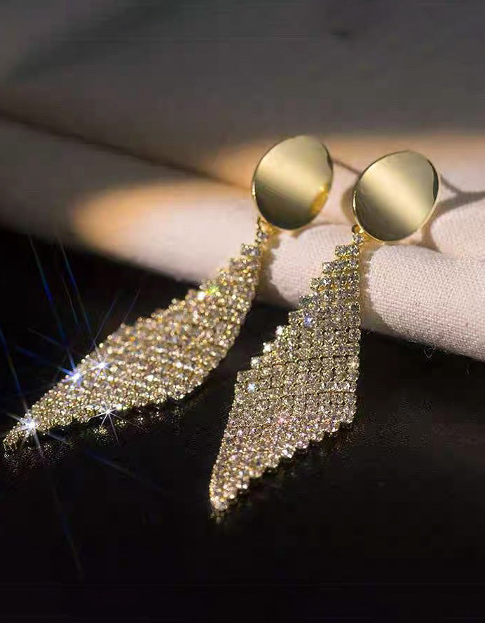 Brincos pendentes dourados com losangos totalmente adornados com strass para festas formais
