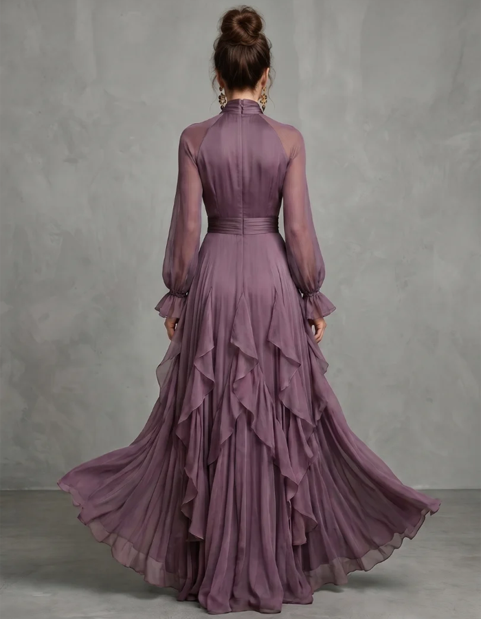 Vestido maxi lilás-claro de chiffon com laço ao pescoço, mangas compridas, folhos, corte em A e comprimento até ao chão