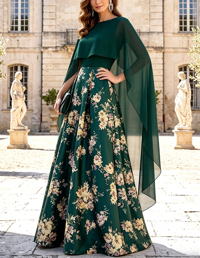 Abito lungo svasato in raso verde con mantella in chiffon, scollo a barca e stampa floreale