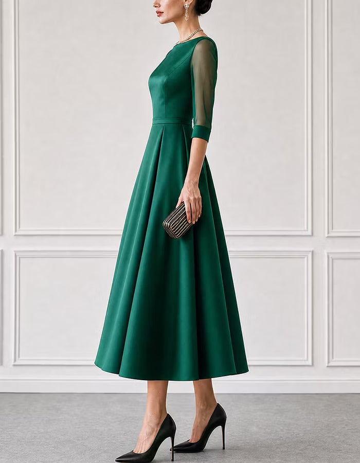 Vestido midi verde de satén con escote barco y mangas de malla de tres cuartos