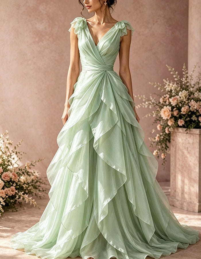 Vestido largo de organza con escote profundo en V, hombros con volantes, lazo y cintura cruzada con torsión