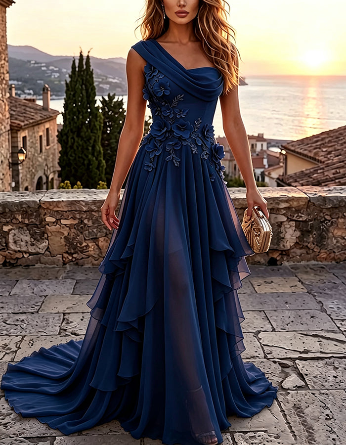 Abito maxi giallo a trapezio in chiffon a balze, con drappeggio monospalla e applicazione floreale 3D