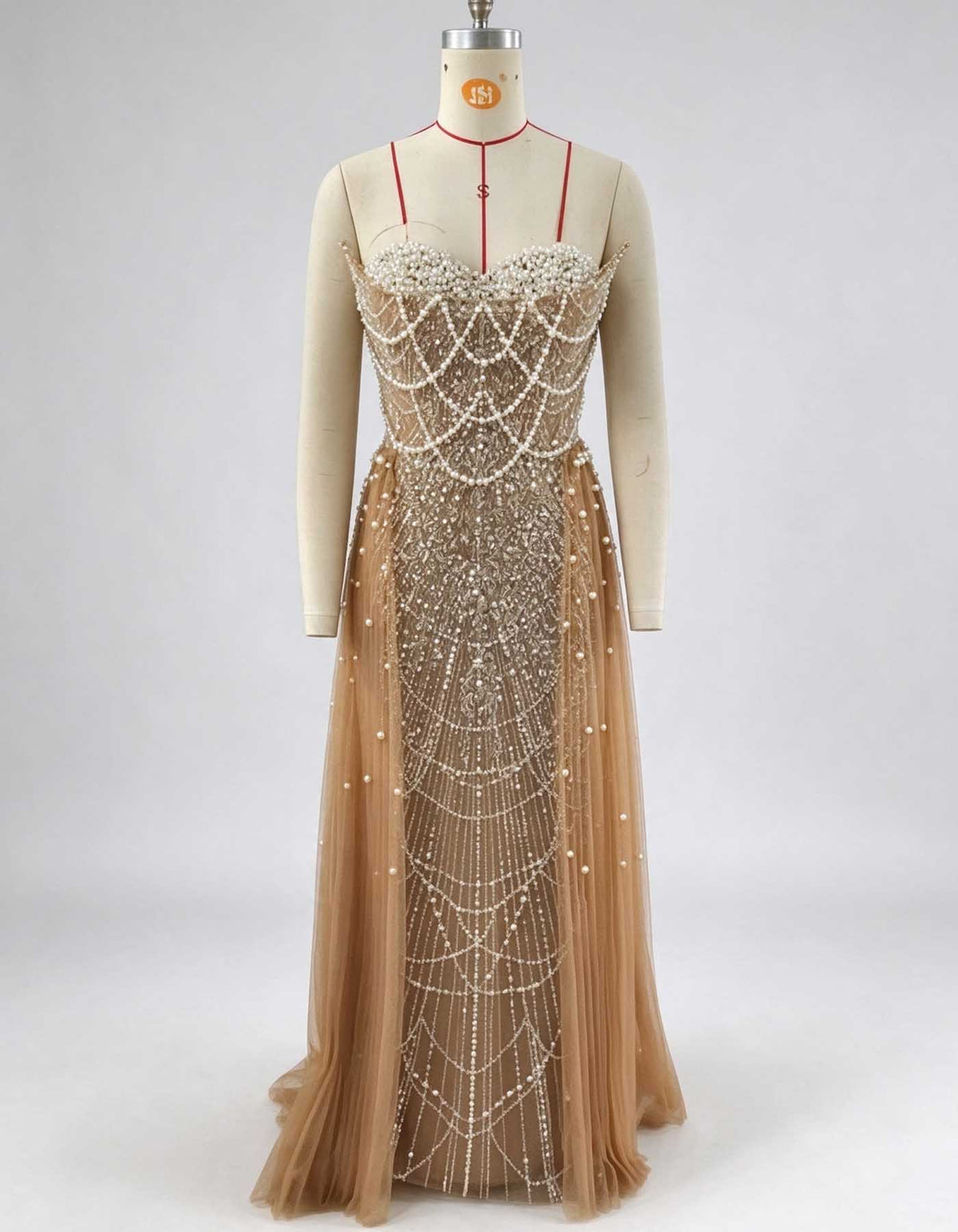 Vestido de noche línea A color champán, sin tirantes, con perlas, pedrería y cuentas