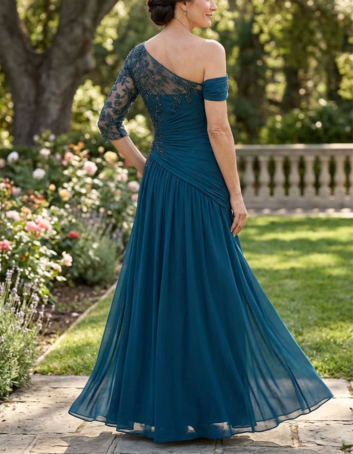 Vestido largo de gasa color verde azulado con un hombro descubierto, efecto ilusión y mangas tres cuartos