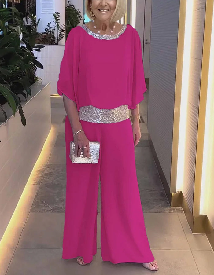 Completo due pezzi rosa con top in chiffon e paillettes e pantaloni
